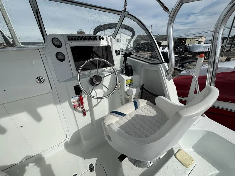 Slide: The Image of Cockpit of 2005 Polar 2300 boat with steering wheel and control panel. - 15