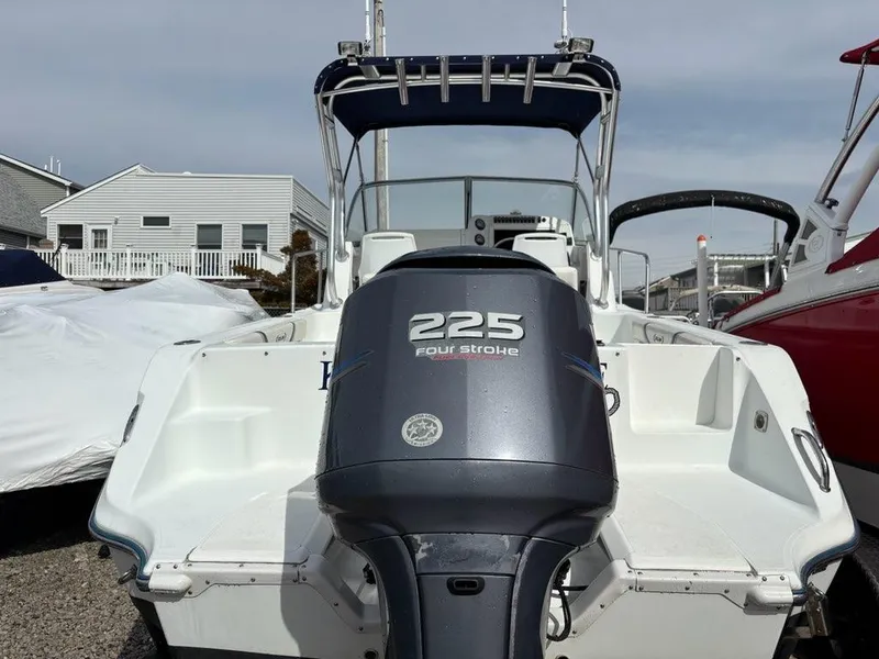 Slide: The Image of 2005 Polar 2300 boat with 225 four-stroke engine, docked outdoors. - 18