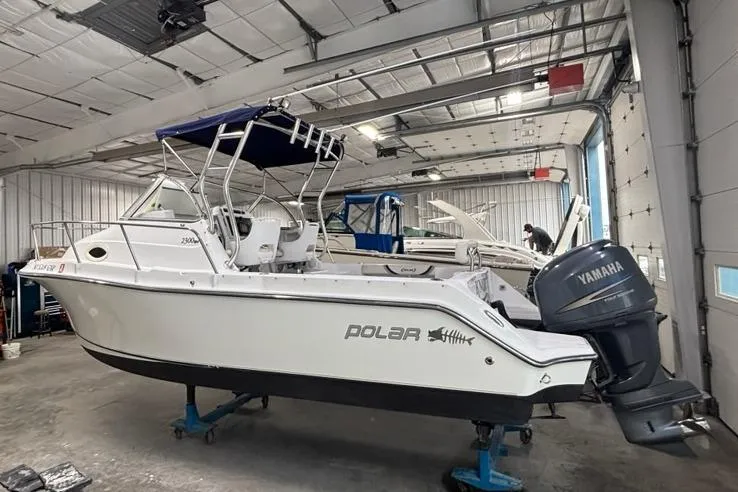 Slide: The Image of 2005 Polar 2300 boat with Yamaha engine in a garage setting. - 19
