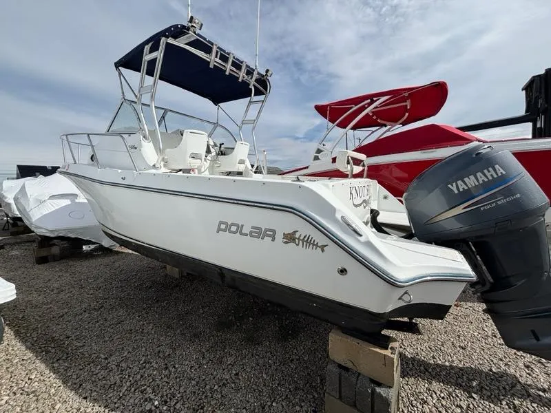 Slide: The Image of 2005 Polar 2300 boat with Yamaha outboard motor, displayed on gravel lot. - 2