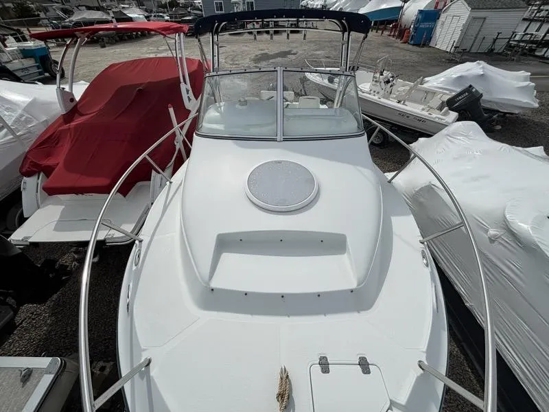 Slide: The Image of 2005 Polar 2300 boat with white deck, docked among other boats. - 3