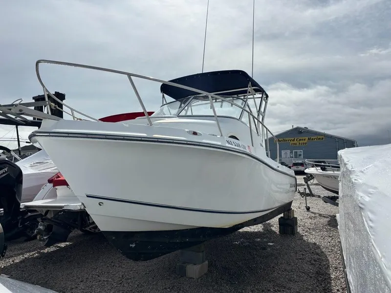 Slide: The Image of 2005 Polar 2300 boat on display at a marina, overcast sky. - 5