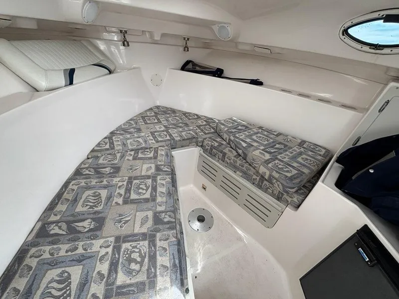 Slide: The Image of 2005 Polar 2300 boat cabin with patterned cushions and compact storage. - 7