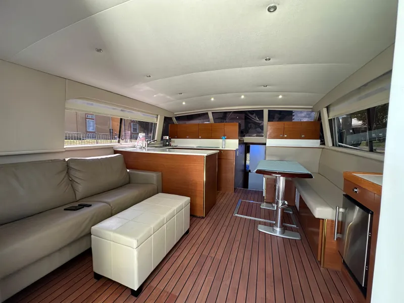 Slide: The Image of Interior of a 1985 Bertram 46 Convertible yacht with modern furnishings and wood flooring. - 14