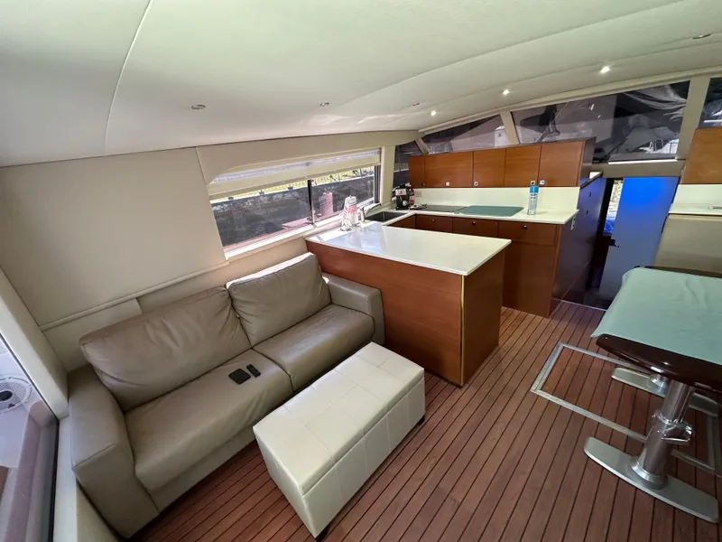 Slide: The Image of Interior of 1985 Bertram 46 Convertible yacht with modern furnishings and wooden flooring. - 16