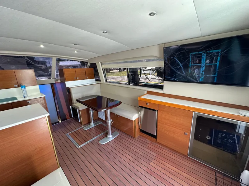Slide: The Image of Interior of 1985 Bertram 46 Convertible yacht with modern furnishings and wood flooring. - 17