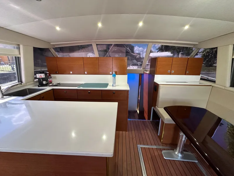 Slide: The Image of Interior of 1985 Bertram 46 Convertible yacht with modern kitchen and dining area. - 20