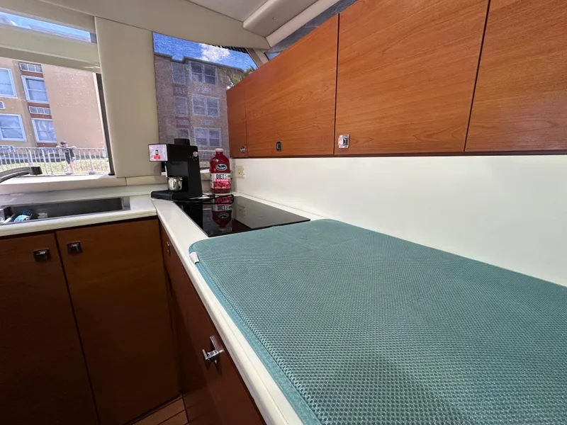 Slide: The Image of Interior of 1985 Bertram 46 Convertible yacht kitchen with wooden cabinets and countertop. - 21