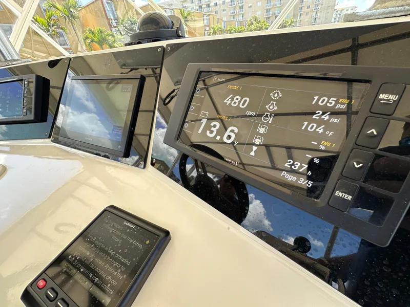 Slide: The Image of Control panel of a 1985 Bertram 46 Convertible yacht, displaying navigation and engine data. - 30