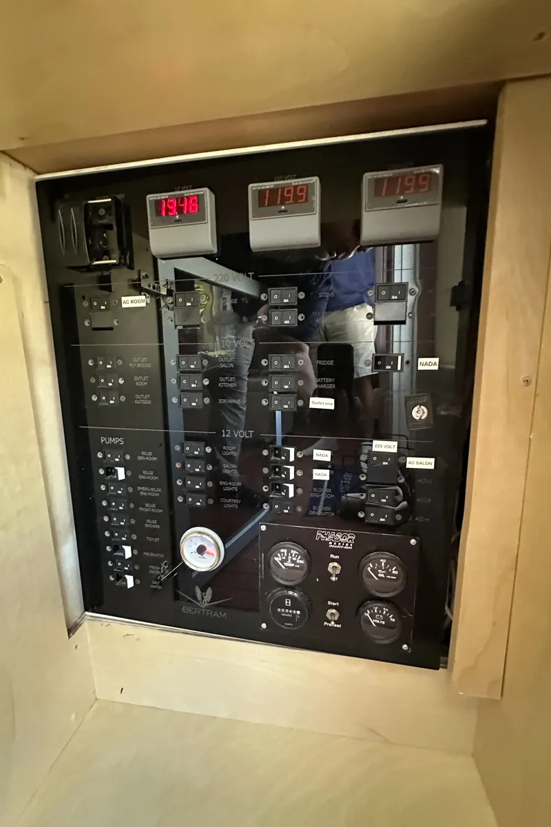 Slide: The Image of Electrical panel of a 1985 Bertram 46 Convertible boat, featuring gauges and switches. - 35