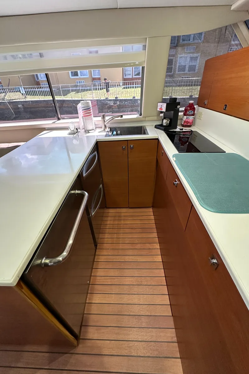 Slide: The Image of 1985 Bertram 46 Convertible yacht kitchen with modern appliances and wooden flooring. - 36