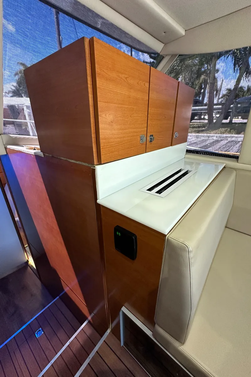 Slide: The Image of 1985 Bertram 46 Convertible interior with wooden cabinetry and seating. - 38