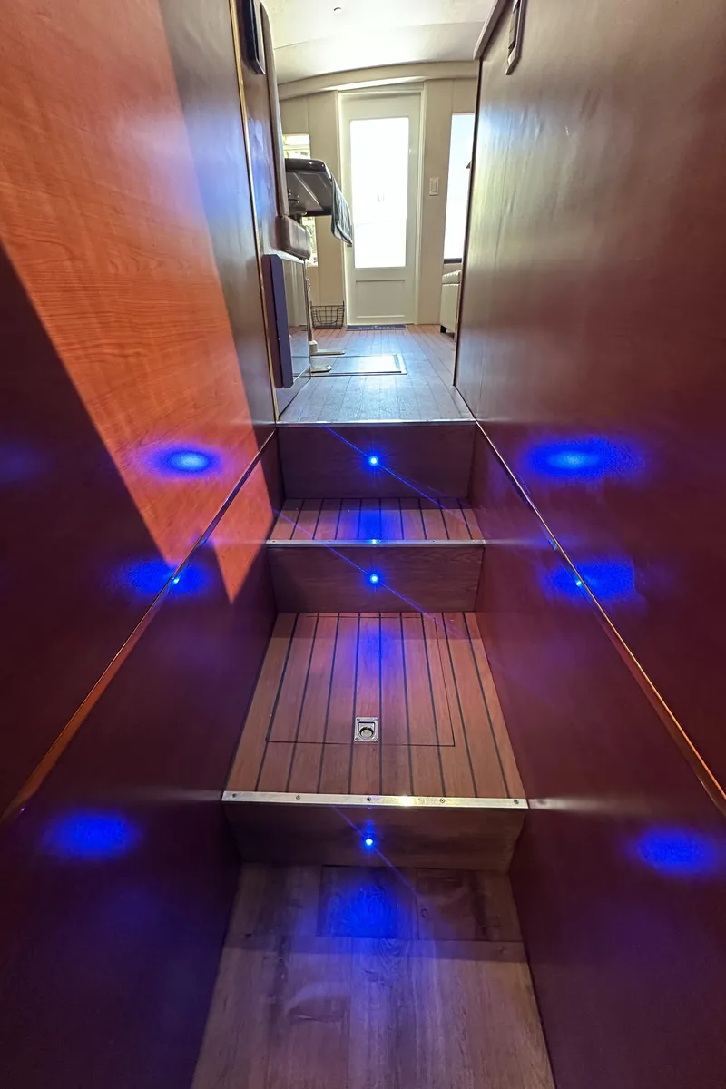 Slide: The Image of Staircase with blue LED lights inside a 1985 Bertram 46 Convertible yacht. - 39
