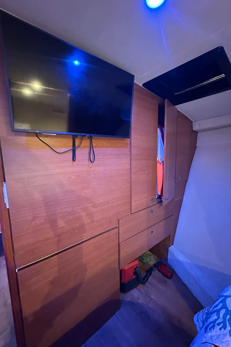 Slide: The Image of Interior of 1985 Bertram 46 Convertible with TV and wooden cabinetry. - 41