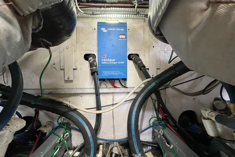 Slide: The Image of Engine room of 1985 Bertram 46 Convertible with Centaur battery charger and wiring. - 48