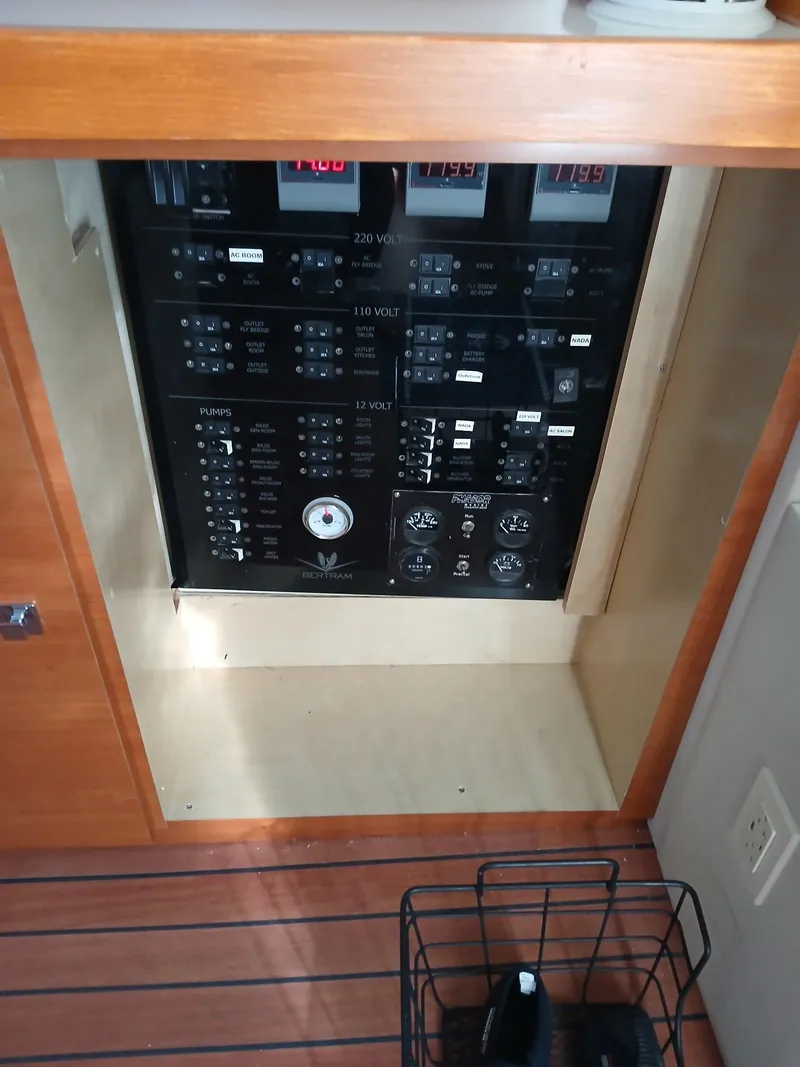 Slide: The Image of Electrical panel of a 1985 Bertram 46 Convertible yacht, featuring various switches and meters. - 8