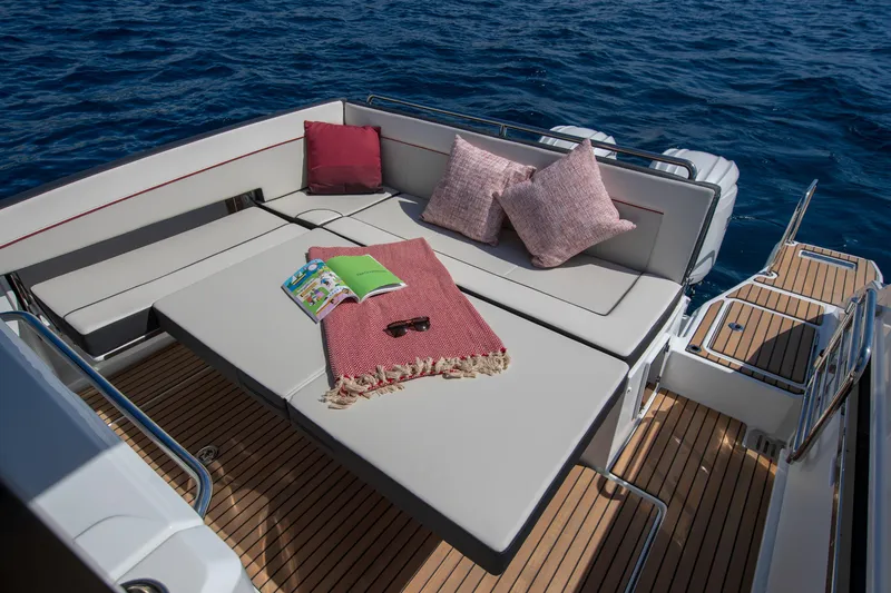 Slide: The Image of Luxurious deck seating on 2025 Jeanneau Leader 9.0 WA S2 yacht with cushions and accessories. - 9