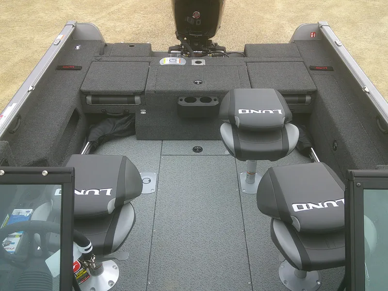 Slide: The Image of 2025 Lund 1875 Impact XS Sport boat interior with four seats and storage compartments. - 15