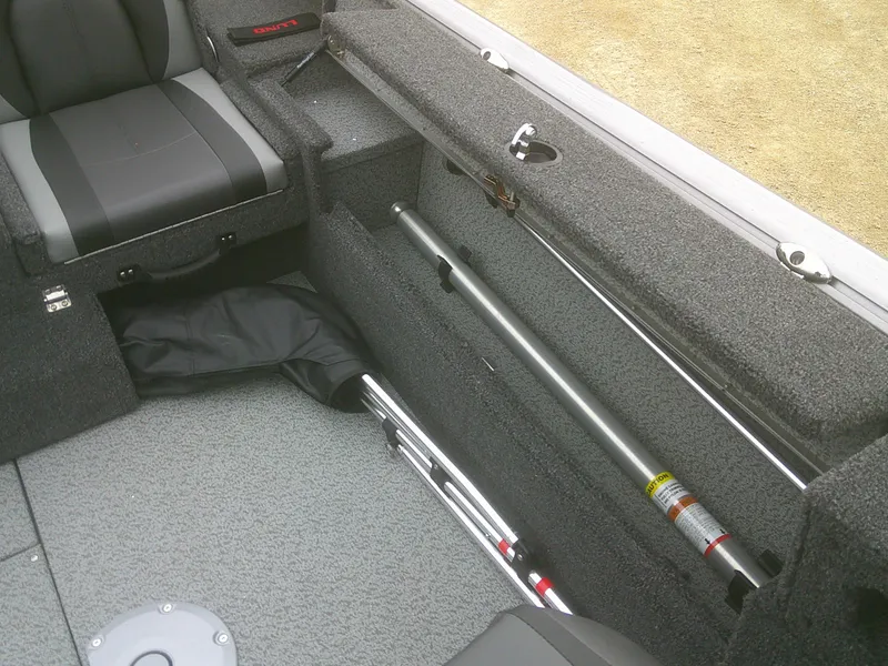 Slide: The Image of 2025 Lund 1875 Impact XS Sport interior with storage compartment and seating. - 21