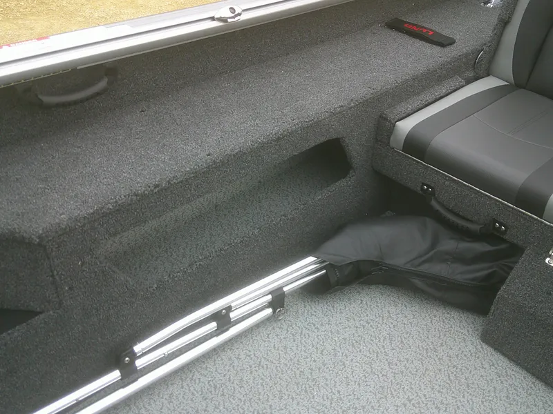 Slide: The Image of Interior of 2025 Lund 1875 Impact XS Sport boat, featuring seating and storage compartments. - 22