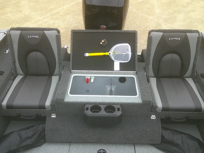 Slide: The Image of 2025 Lund 1875 Impact XS Sport boat interior with seating and fishing gear. - 23