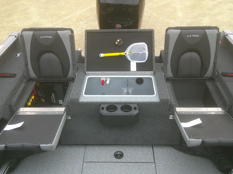 Slide: The Image of 2025 Lund 1875 Impact XS Sport boat interior with seating and storage compartments. - 24