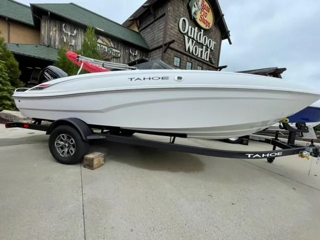 Slide: The Image of 2025 Tahoe T18 boat on trailer outside Outdoor World store. - 0