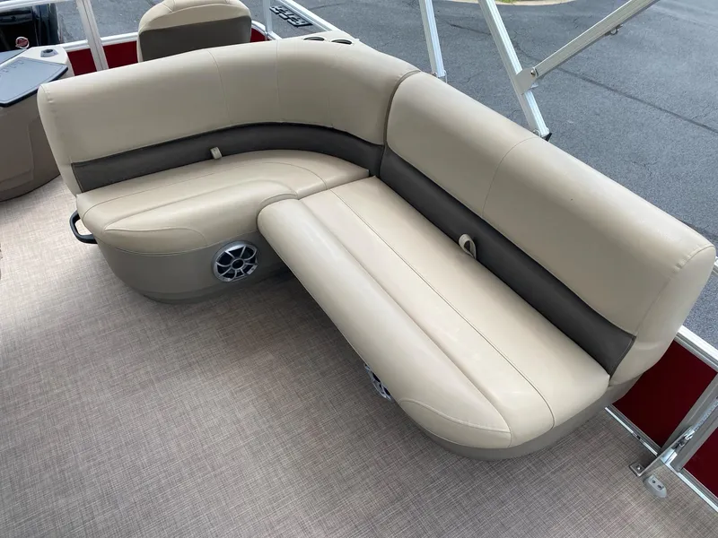 Slide: The Image of 2025 Sun Tracker Bass Buggy 18 DLX pontoon boat with beige seating and carpeted floor. - 11