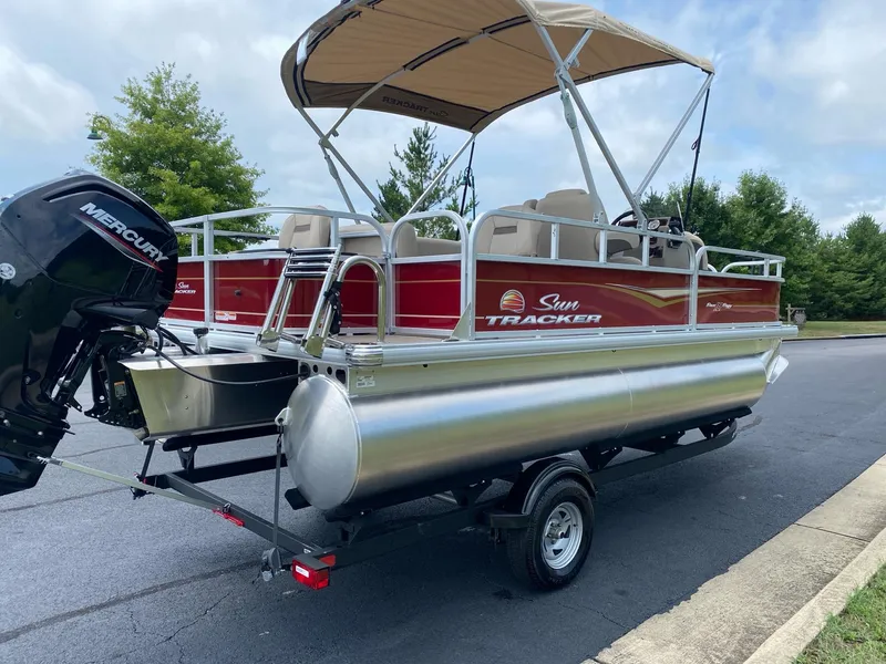 Slide: The Image of 2025 Sun Tracker Bass Buggy 18 DLX pontoon boat with canopy on trailer. - 4