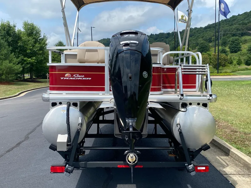 Slide: The Image of 2025 Sun Tracker Bass Buggy 18 DLX pontoon boat on trailer, rear view. - 6