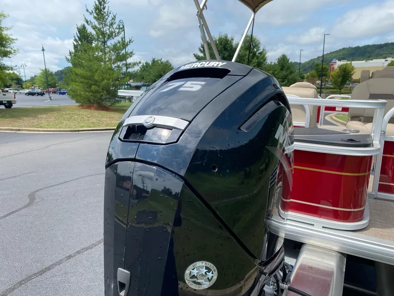 Slide: The Image of 2025 Sun Tracker Bass Buggy 18 DLX with Mercury 75 outboard motor in parking lot. - 7