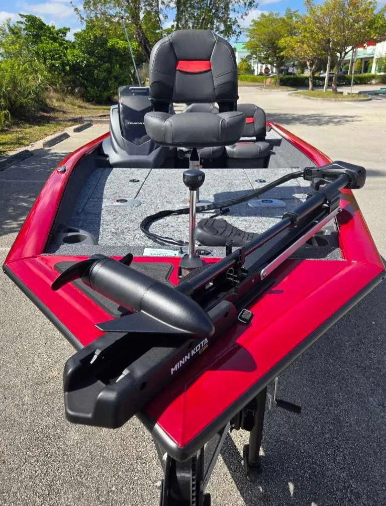 Slide: The Image of 2025 Tracker Pro Team 175 Crappie Edition boat with red trim and fishing seat. - 2