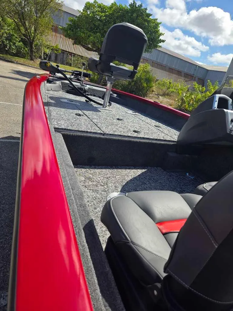 Slide: The Image of 2025 Tracker Pro Team 175 Crappie Edition boat with red trim and seating. - 7