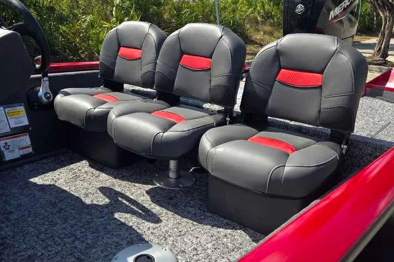 Slide: The Image of 2025 Tracker Pro Team 175 Crappie Edition boat seats with red accents and gray upholstery. - 8