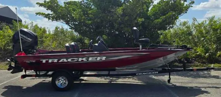 Slide: The Image of 2025 Tracker Pro Team 175 Crappie Edition boat, red, parked outdoors. - 80