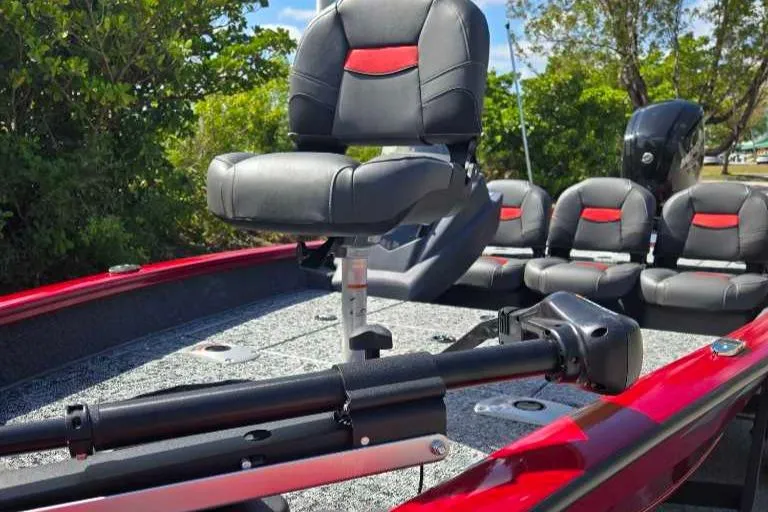 Slide: The Image of 2025 Tracker Pro Team 175 Crappie Edition boat with seating and motor, in a lush outdoor setting. - 9