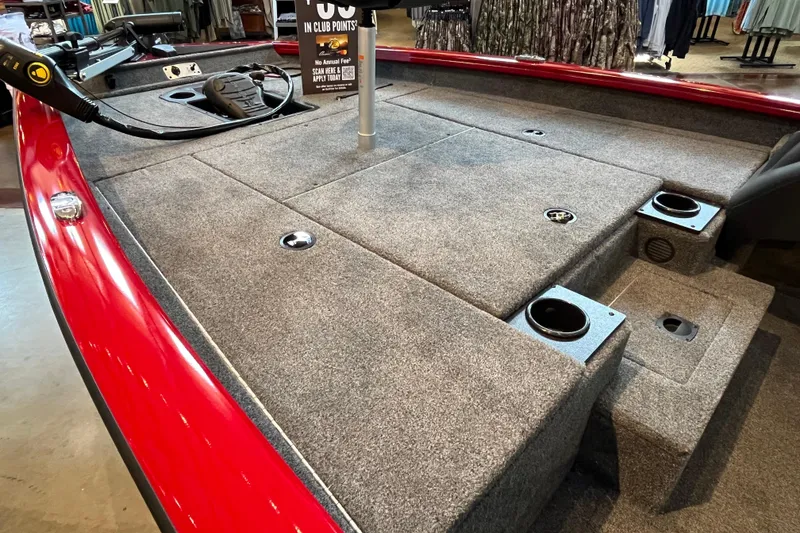 Slide: The Image of 2025 Tracker Pro Team 175 boat interior with carpeted deck and storage compartments. - 6