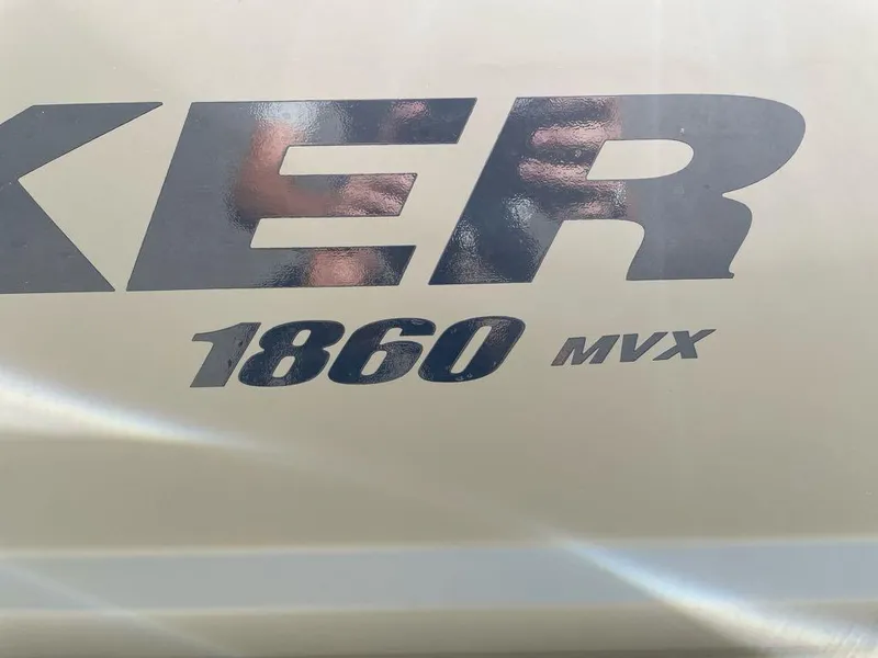 Slide: The Image of 2025 Tracker Grizzly 1860 CC boat logo with "1860 MVX" text. - 2