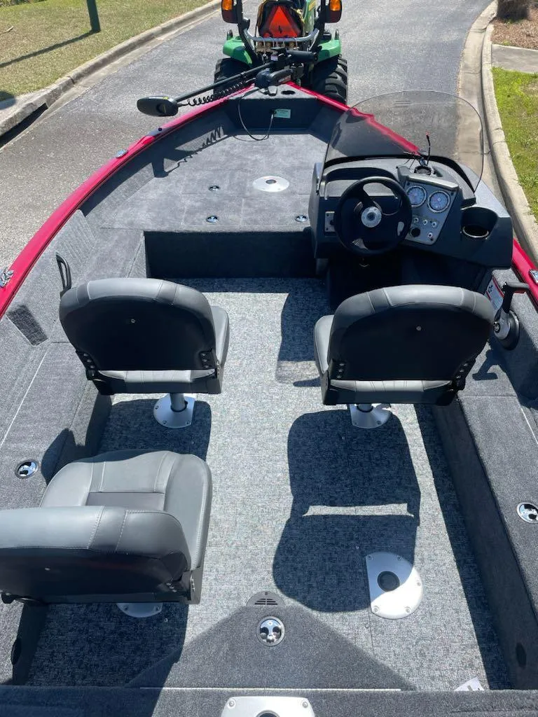 Slide: The Image of 2025 Tracker Pro Guide V-16 SC boat interior with dual seats and steering console. - 2