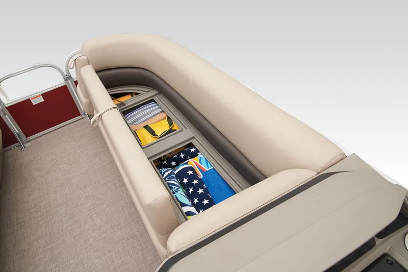 Slide: The Image of 2025 Sun Tracker Party Barge 18 DLX steering console with beige seating and controls. - 12