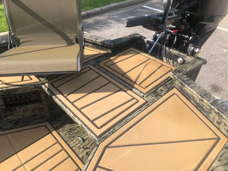 Slide: The Image of 2025 Tracker Grizzly 1650 T Prairie Wings Edition boat interior with camo design and seating. - 10