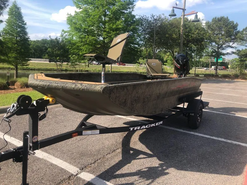 Slide: The Image of 2025 Tracker Grizzly 1650 T Prairie Wings Edition boat on trailer in parking lot. - 11