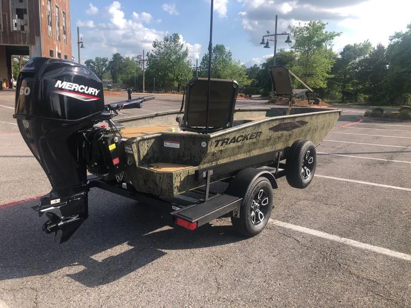 Slide: The Image of 2025 Tracker Grizzly 1650 T Prairie Wings Edition boat with Mercury engine in parking lot. - 3