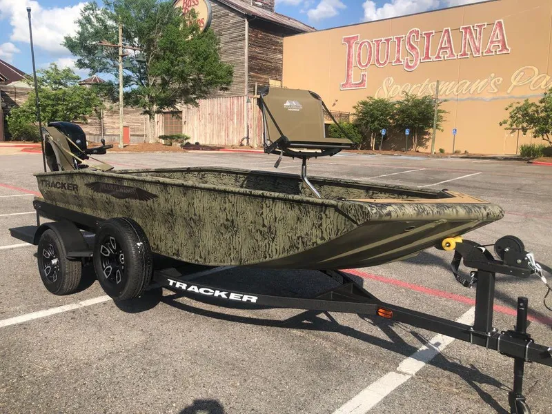 Slide: The Image of 2025 Tracker Grizzly 1650 T Prairie Wings Edition boat on trailer in parking lot. - 5