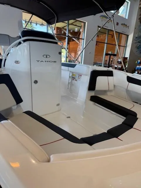 Slide: The Image of 2023 Tahoe 2150 CC boat interior with seating and canopy. - 9