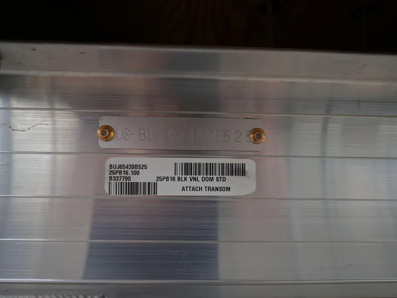 Slide: The Image of 2025 Sun Tracker Party Barge 16 DLX transom with identification plate and barcode. - 12