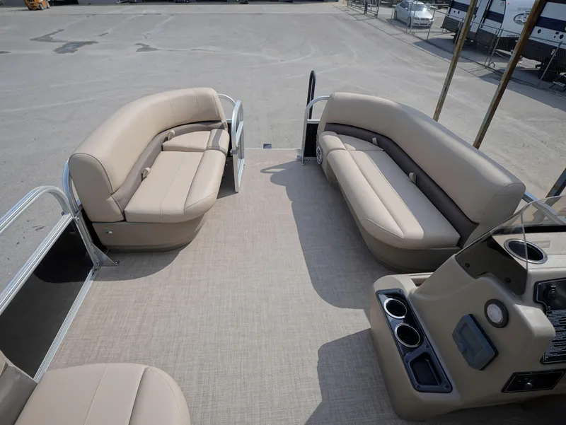 Slide: The Image of 2025 Sun Tracker Party Barge 16 DLX interior with beige seating and cup holders. - 5