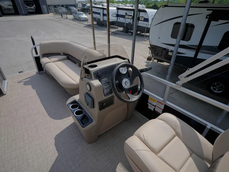 Slide: The Image of 2025 Sun Tracker Party Barge 16 DLX interior with steering console and seating. - 6