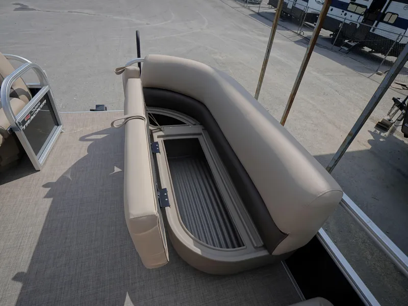 Slide: The Image of 2025 Sun Tracker Party Barge 16 DLX with open storage compartment on deck. - 8