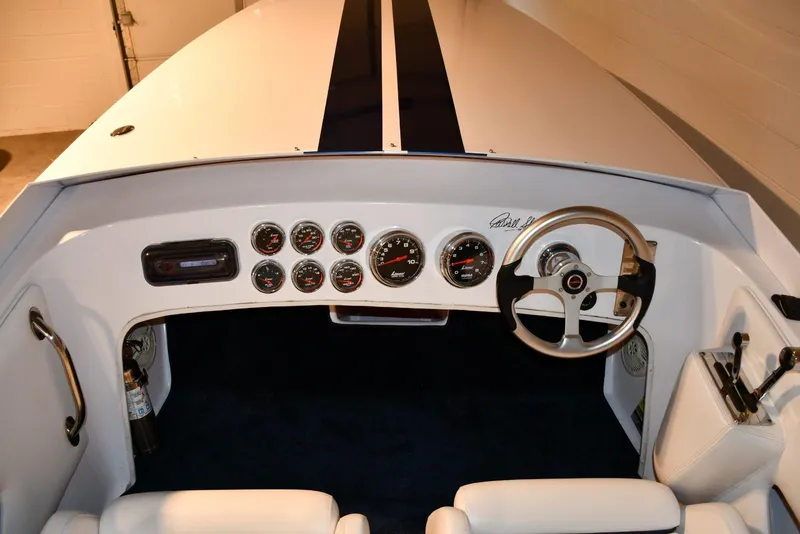 Slide: The Image of 2007 Donzi Carol Shelby 22 Classic boat dashboard with gauges and steering wheel. - 19